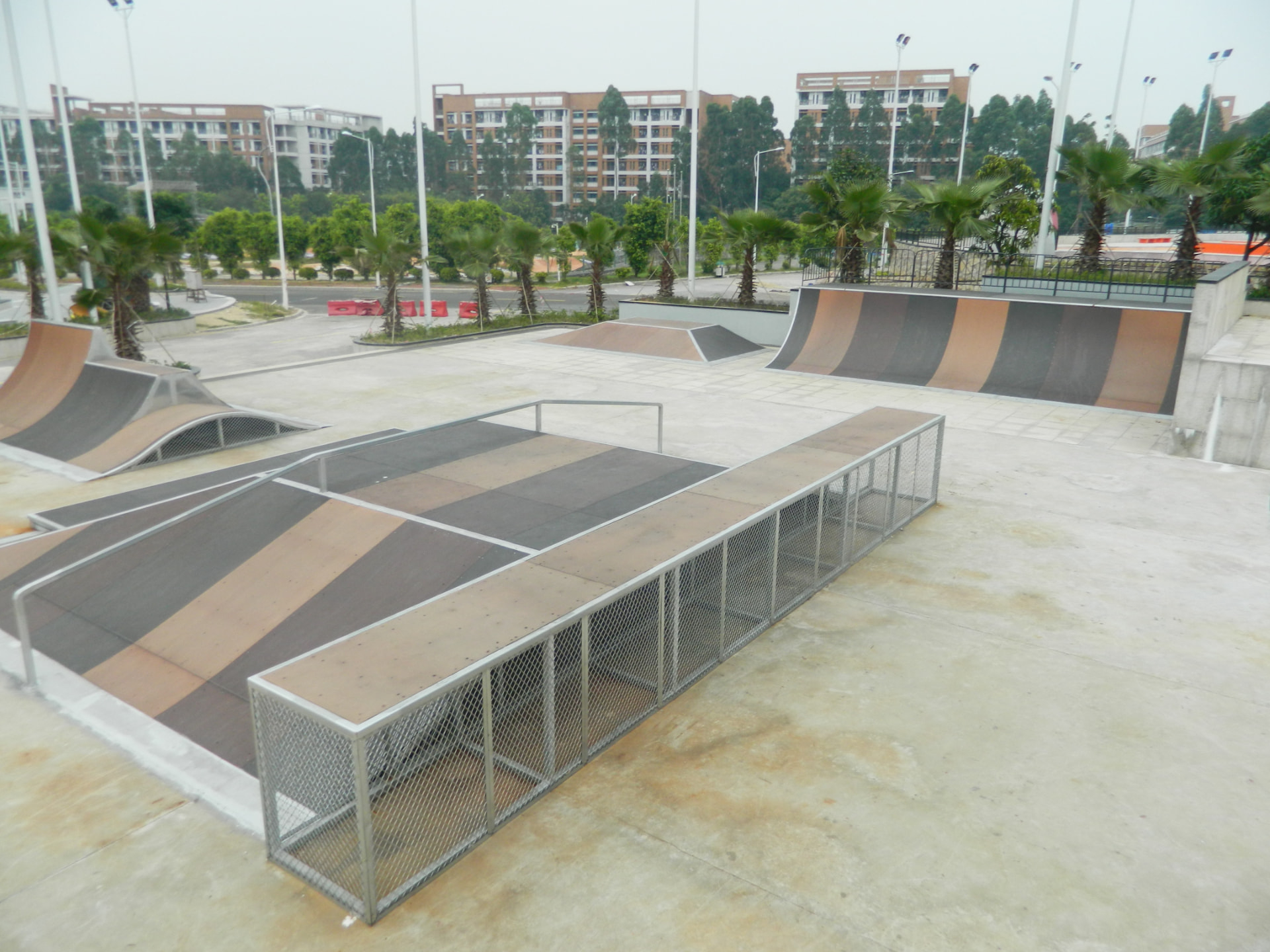BMX and scooter riding area with ramps and caged edges at Guangzhou University City Mega Skatepark