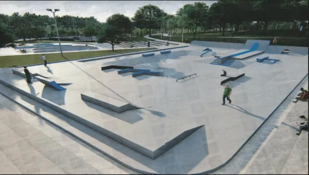 Large concrete skate plaza with blue ledges and ramps beside a park