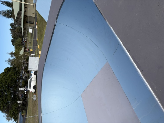 New steel coping installed on a skatepark transition